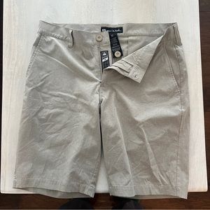 Travis Mathew tan golf shorts.